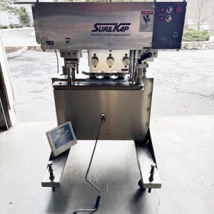 SURE KAP MODEL SK 600 IN-LINE CAP TIGHTENER/RETORQUER 6 SPINDLE W/THREE SETS OF SPINDLES